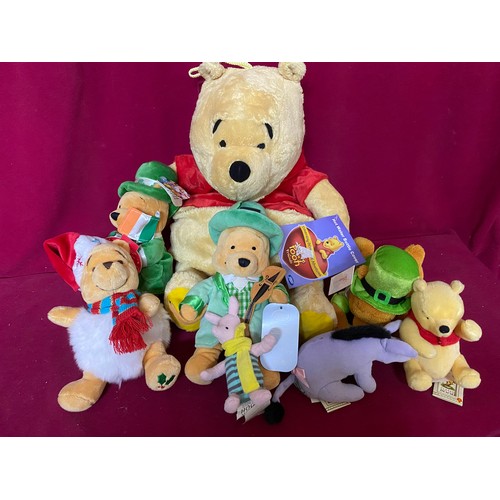 647 - Selection of Disney Winnie-the-Pooh soft toys and hot water bottle holder.