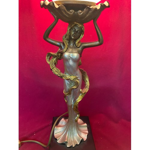 694 - Table lamp of woman holding frosted circular shade by JJ Valiant