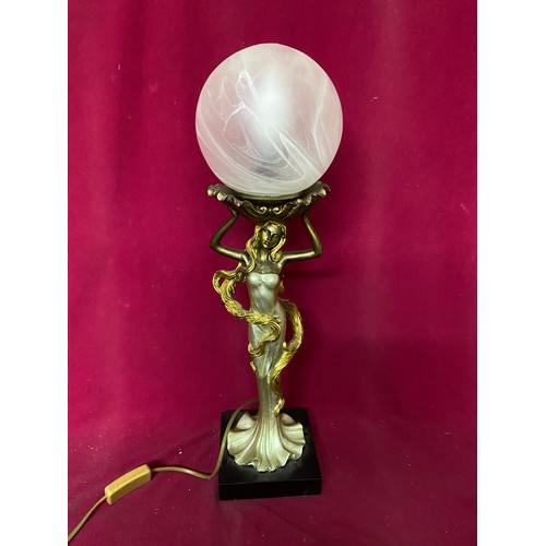 694 - Table lamp of woman holding frosted circular shade by JJ Valiant