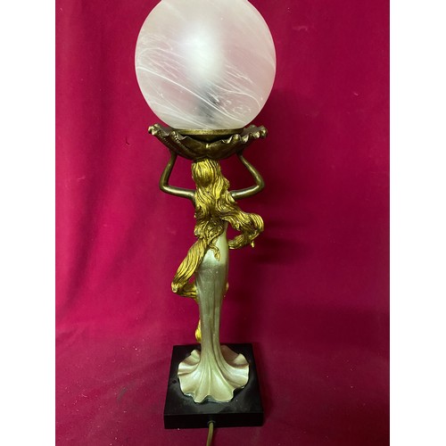 694 - Table lamp of woman holding frosted circular shade by JJ Valiant