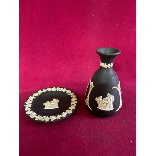 172 - 2 pieces of black and white Wedgewood jasperware, a bud vase measuring 12 cms tall and a pin dish