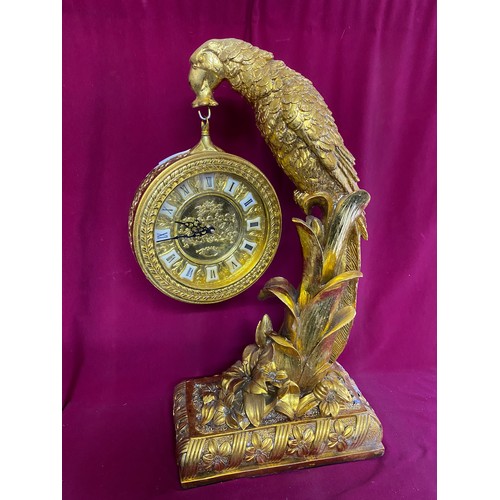 233 - Ornate gold parrot perched on branch holding round clock measuring 70 cms tall