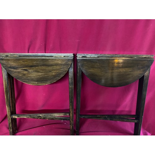 329 - A pair of folding coffee tables measuring 38 cms diameter