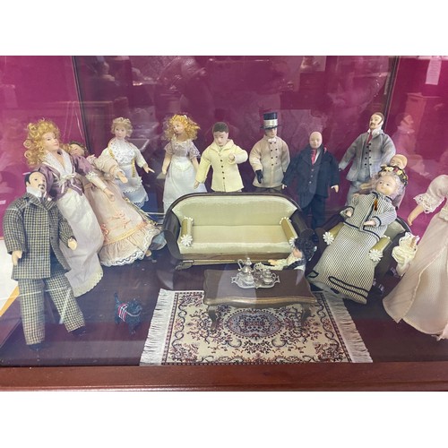 355 - 'Scenes of Victorian life' figurines of living room in display cabinet measuring 41 x 30 x 30 cms ta... 