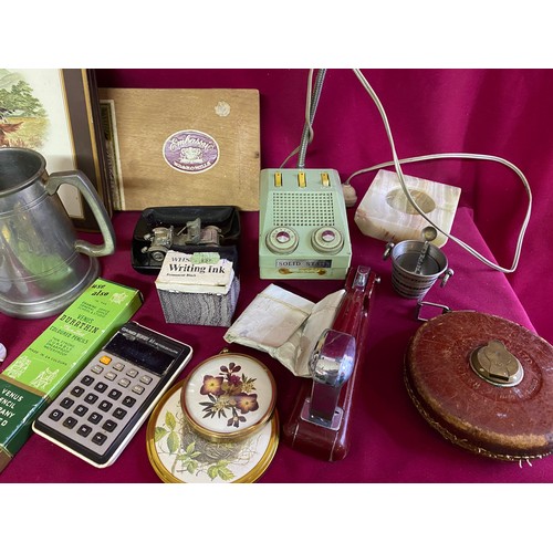 363 - Assortment of vintage curios including stapler, lamp, tape measure and table mats.