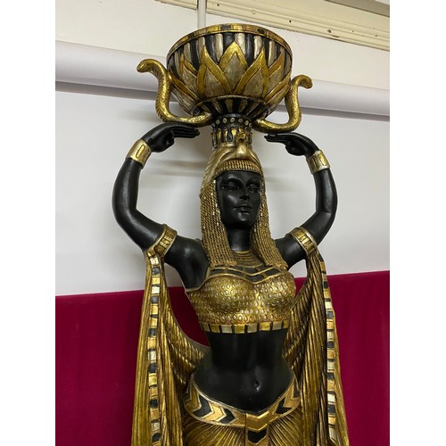 102 - Egyptian style figure of woman holding bowl in black and gold. 135cms tall