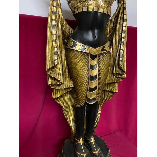 102 - Egyptian style figure of woman holding bowl in black and gold. 135cms tall