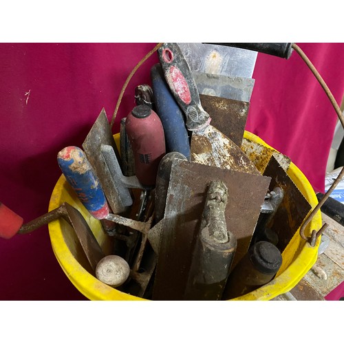 487 - A bucket full of building tools, floats, trowels etc