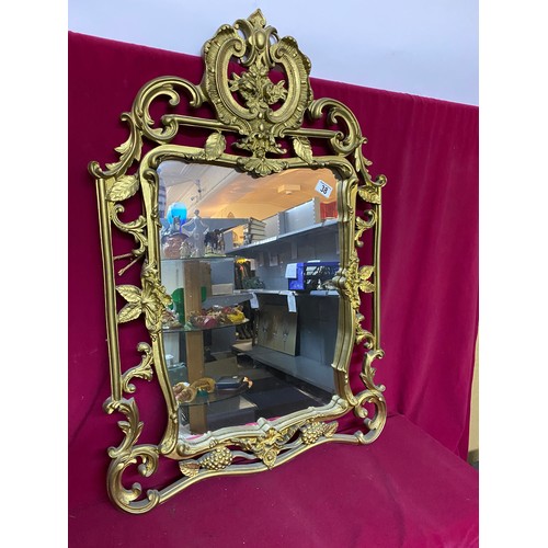 38 - Ornate gold framed mirror measuring 62 x 95 cms tall