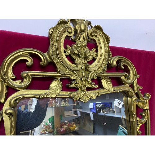 38 - Ornate gold framed mirror measuring 62 x 95 cms tall