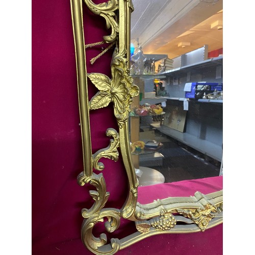 38 - Ornate gold framed mirror measuring 62 x 95 cms tall