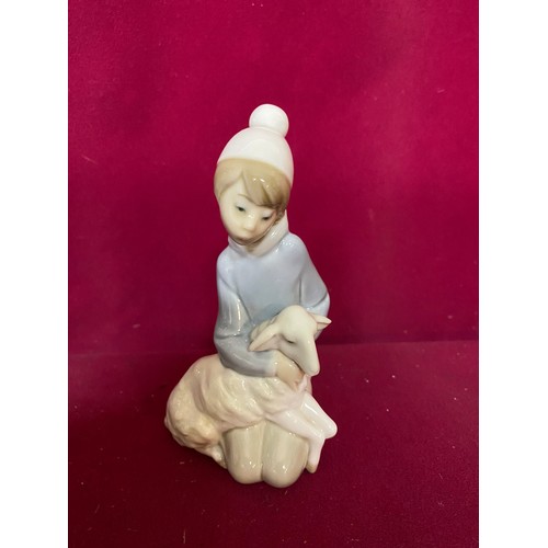 65 - 2 x Lladro figurines, 'boy with lamb' standing 15 cms tall and 'Girl with basket, dove on lap' stand... 