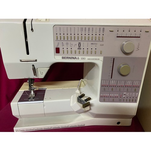 57 - A Bernina 1230 sewing machine with spare cotton reels and accessories, fully working