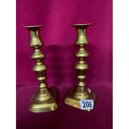 206 - 2 Pairs of brass candlestick holders, largest measuring 22 cms tall