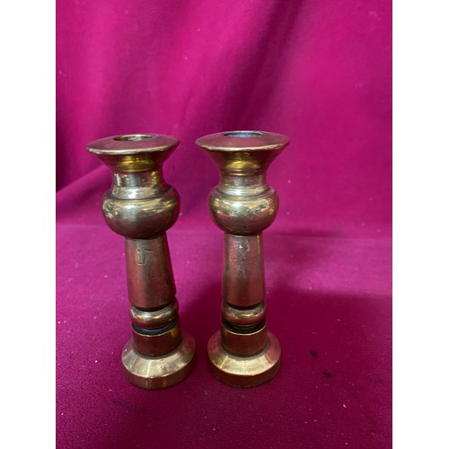 206 - 2 Pairs of brass candlestick holders, largest measuring 22 cms tall