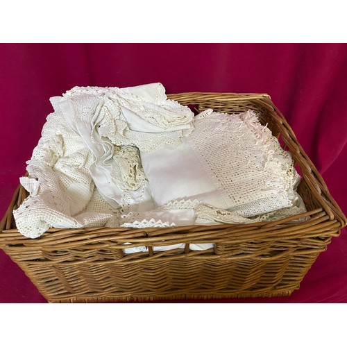 580 - Antique linen, silk and lace tablecloths, napkins, pillowcases and runners in wicker basket.