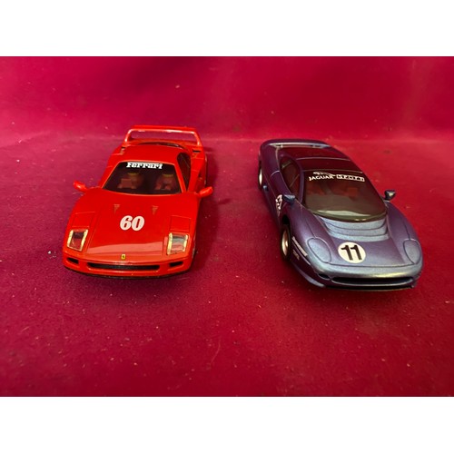 754 - Two Scalextric Hornby Ltd cars, Ferrari red car and Jaguar Sport blue car.