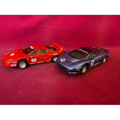 754 - Two Scalextric Hornby Ltd cars, Ferrari red car and Jaguar Sport blue car.