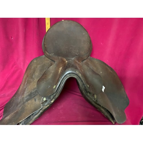 168 - 2 brown leather saddles with bridle and reins.