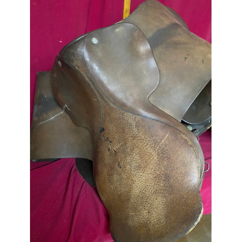 168 - 2 brown leather saddles with bridle and reins.