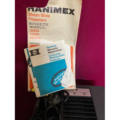 259 - Hanimex Rondette 1200A slide projector and varios magazines, tested and working.