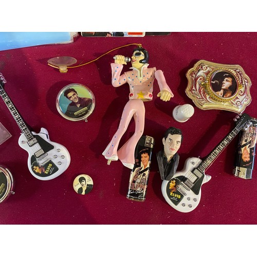 31 - Collection of Elvis memorabilia including lighters, belt buckle, badges and ephemera.