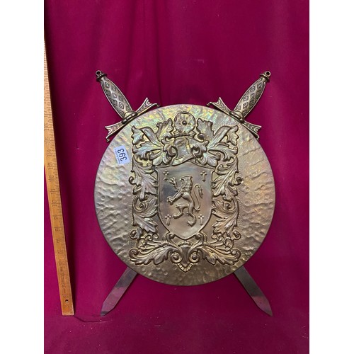 393 - Decorative brass shield and 2 swords.