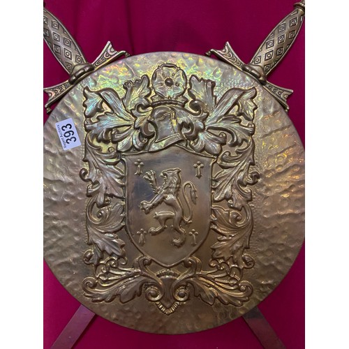 393 - Decorative brass shield and 2 swords.