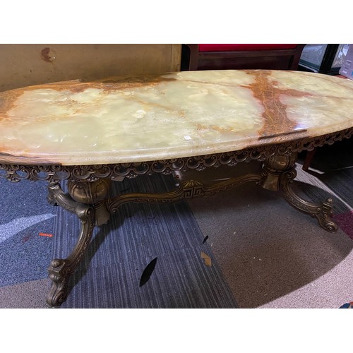 450 - Oval shaped Brass and Onyx coffee table 120cms long by 46cms high.