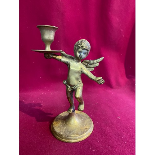 680 - Brass embossed coal bucket standing 36 cms tall and cherub candle holder standing 20 cms tall