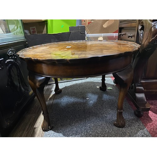 647 - Pie crust edge round coffee table in oak measuring 60 cms diameter with scroll feet