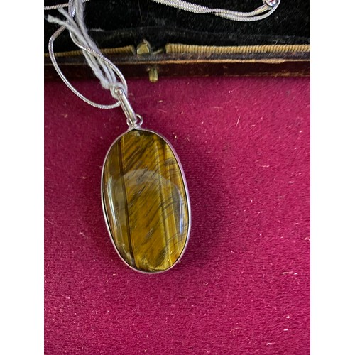 505 - Large Tigers Eye pendant set in silver on silver chain.