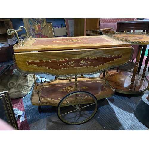 150 - Drinks trolley with decorative inlay top and under shelf, brass trim and wheels. Top shelf extends a... 