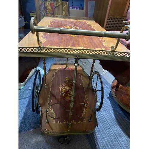 150 - Drinks trolley with decorative inlay top and under shelf, brass trim and wheels. Top shelf extends a... 