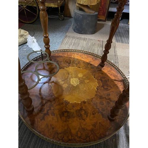 151 - Round drinks table with decorative inlay top and lower shelf, bottle holder and brass trim. 55x62cms