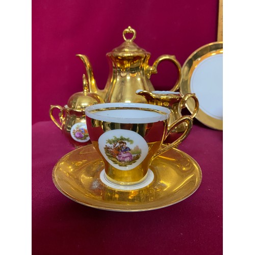 159 - Gold and white coffee set comprising of 6 cups and saucers, coffee pot, 2 plates,milk and sugar bowl