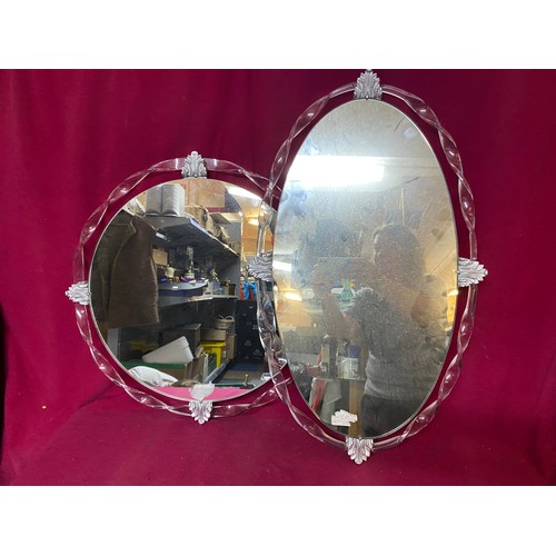 474 - 2 x frameless mirrors with decorative trim, a 70 x 43 cms oval mirror and a 53 cms round mirror