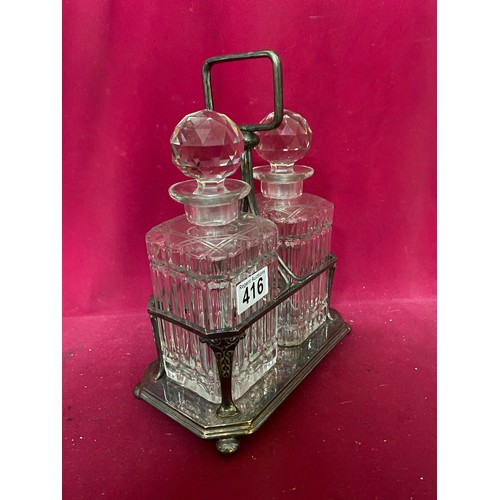 416 - Pair of glass decanters in silver plated display tray