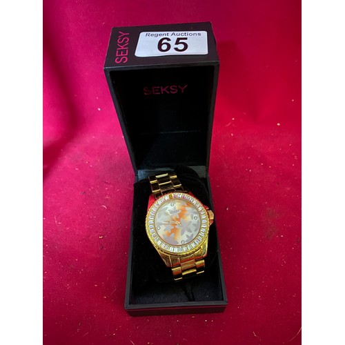 65 - Boxed Seksy watch in gold tone