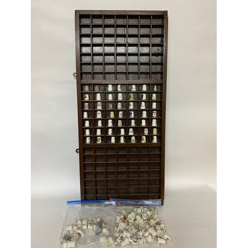 155 - Large thimble rack with selection of assorted thimbles. 83 x 37cms