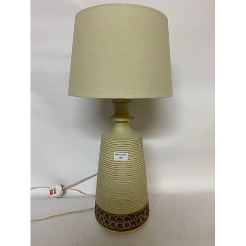 169 - Decorative pottery table lamp with cream shade. 60cms in total