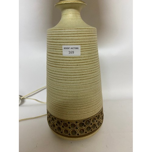 169 - Decorative pottery table lamp with cream shade. 60cms in total