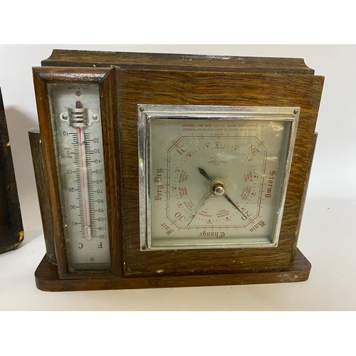 210 - 2 x freestanding Barometers set in wooden frames, both include thermometer and one also has clock .