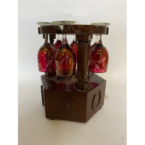 213 - Musical glass holder in wood with 6 cranberry style etched glasses. Will hold bottle in centre, work... 