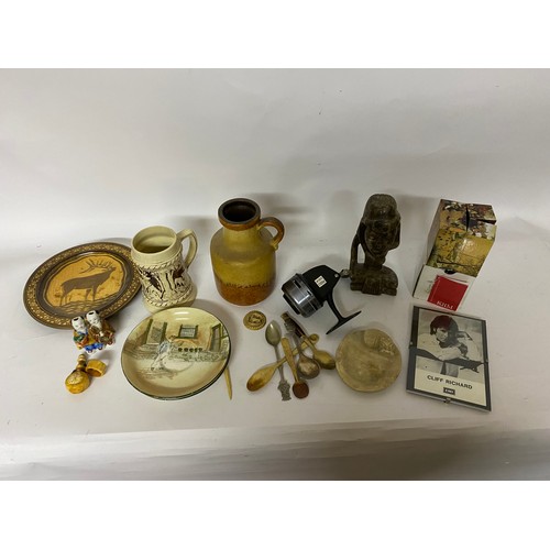 379 - Box of curios including spoons, fishing reel, plates, magic cube etc