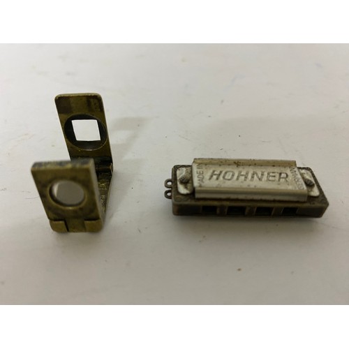 75 - Miniature brass magnifying glass and miniature Hohner harmonica