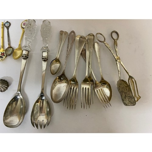 143 - Selection of cutlery including serving spoons, caddy spoons and sugar nips.