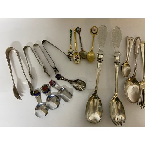 143 - Selection of cutlery including serving spoons, caddy spoons and sugar nips.