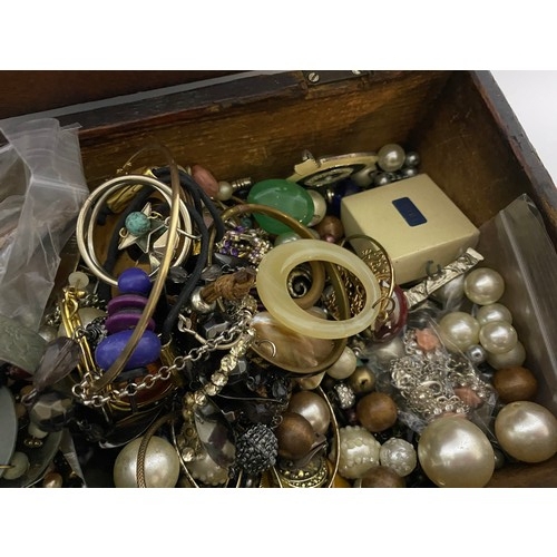 225 - Selection of costume jewellery in wooden box measuring 28 x 18 cms