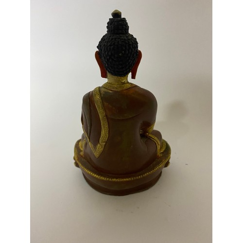 660 - A gold gild and copper Amitabha Budhha statue measuring 15 cms tall